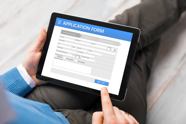 Sample application form on tablet computer, man using tablet Sample application form on tablet computer, man using tablet